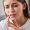 Can not take the pain. Frustrated young women suffering from toothache and touching her cheek with her fingers while sitting on the sofa at home